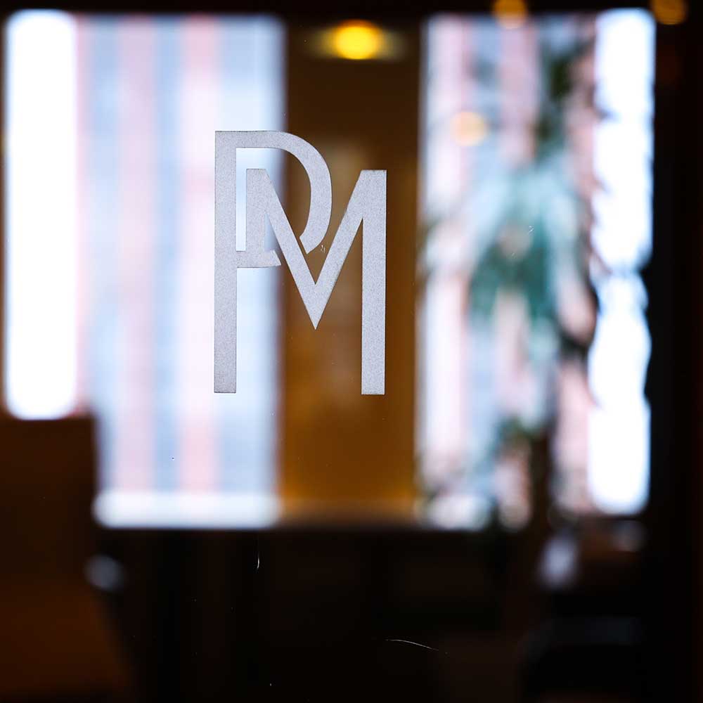 PM-etched-on-glass Personius Melber logo etched on the door at the entrance